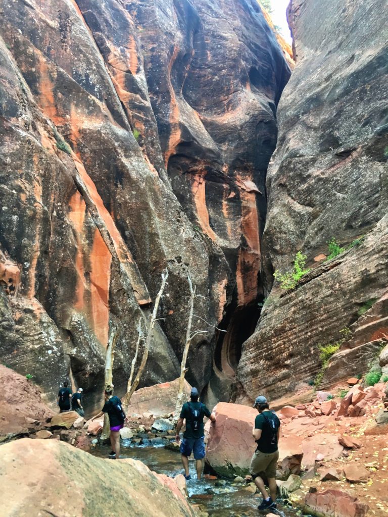 People hiking the narrow canyon at Kanarra Creek