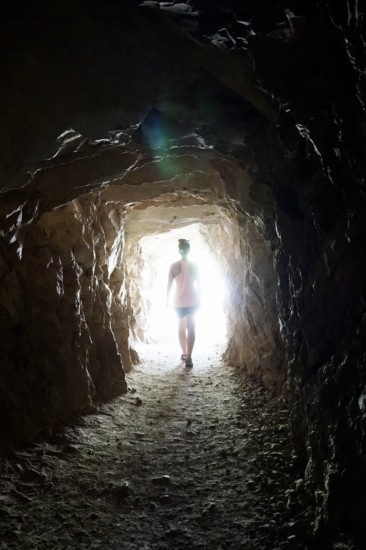 a girl in the glow of a tunnel at upper box canyon falls