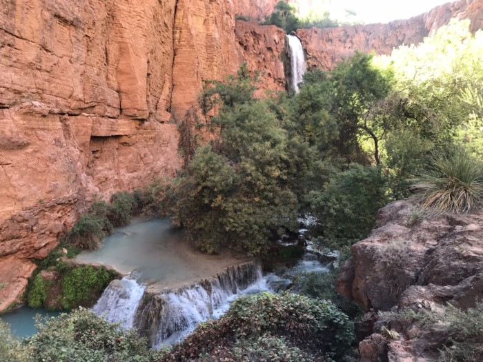 a view of mooney falls on a havasu falls trip from the distance