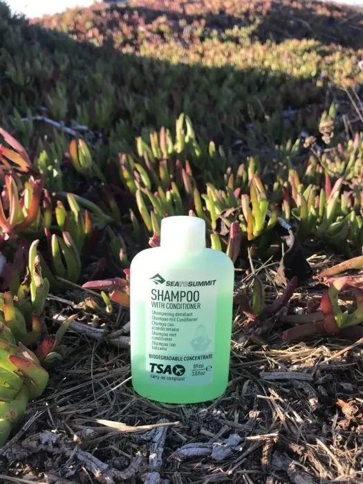 bottle of biodegradable shampoo that is a great product for female hygiene on the road