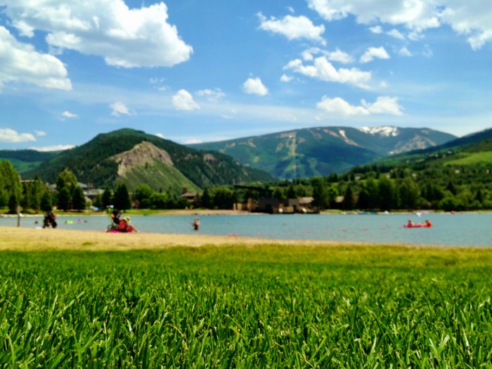 Nottingham Lake in the warmer months with green grass on the mountains in Beaver Creek which is one of the best things to do in vail in summer