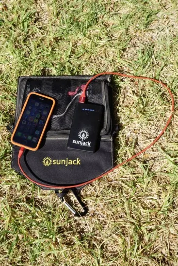 a sunjack charger charging a cell phone which is one of the best gift ideas for hikers and backpackers