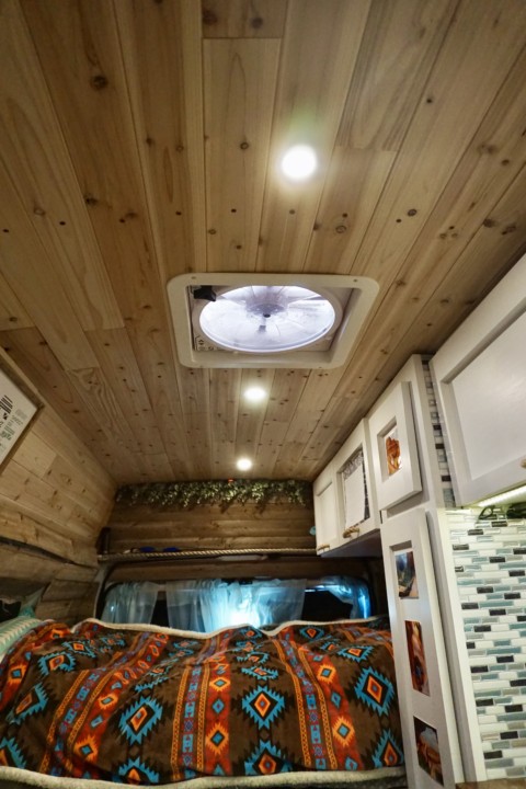 Campervan interior that shows the Maxxfan 5100K installed in the cedar plank ceiling