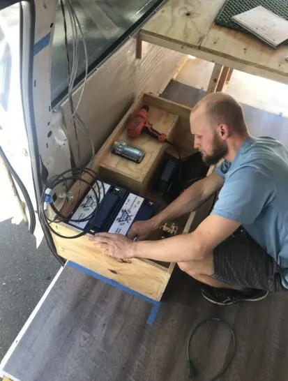 Jake installing our wired electrical system for our campervan.