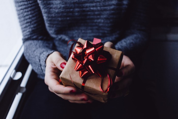 person holding a wrapped gift in hands