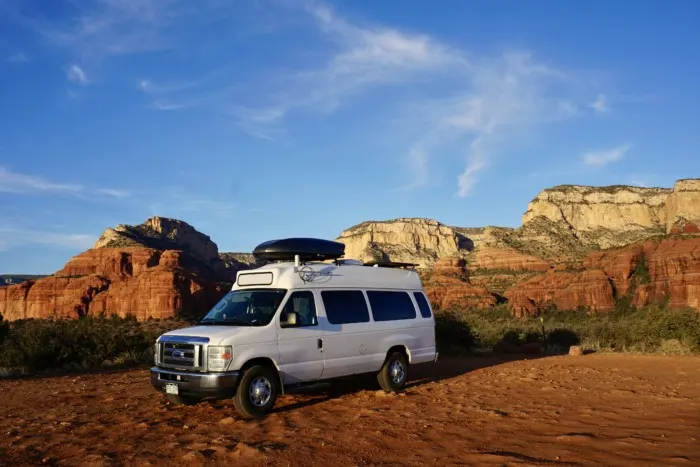a campervan parked with views of Sedona's Red Rock wall, showing an example of always having your home with you, which is a big reason why people do #vanlife