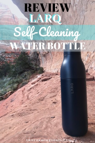 the navy blue LARQ water bottle sitting on the ground in a canyon offering that this bottle is great for hiking