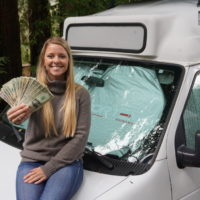 Emily holding money on the hood of our van