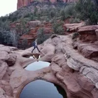 Emily walking across the seven sacred pools, which is a popular destination along soliders pass trail