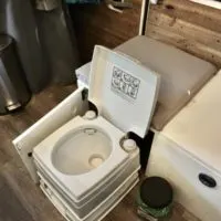 A bathroom cassette toilet with the lid up