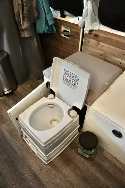 A bathroom cassette toilet with the lid up