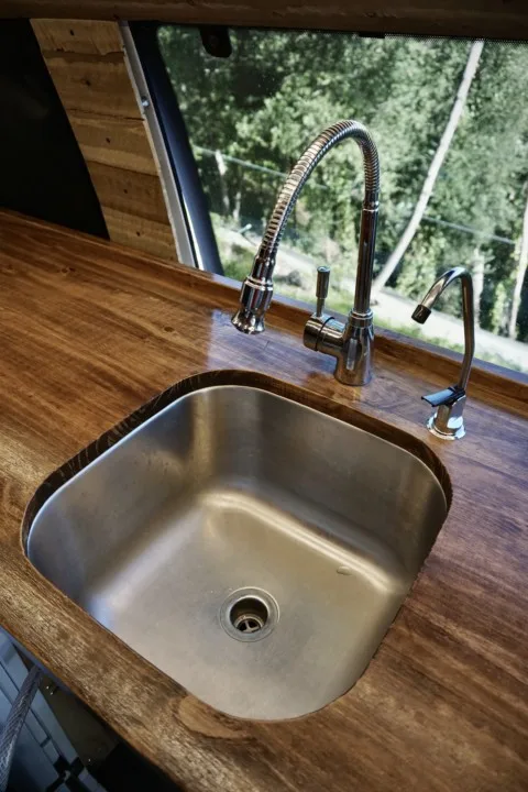 A close up of both water faucets and sink