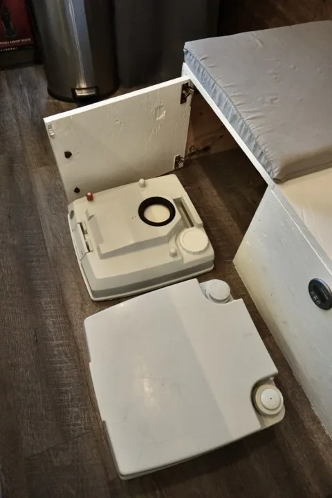 A bathroom cassette toilet split into two tanks