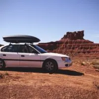 Car in the desert with ski cargo box on top