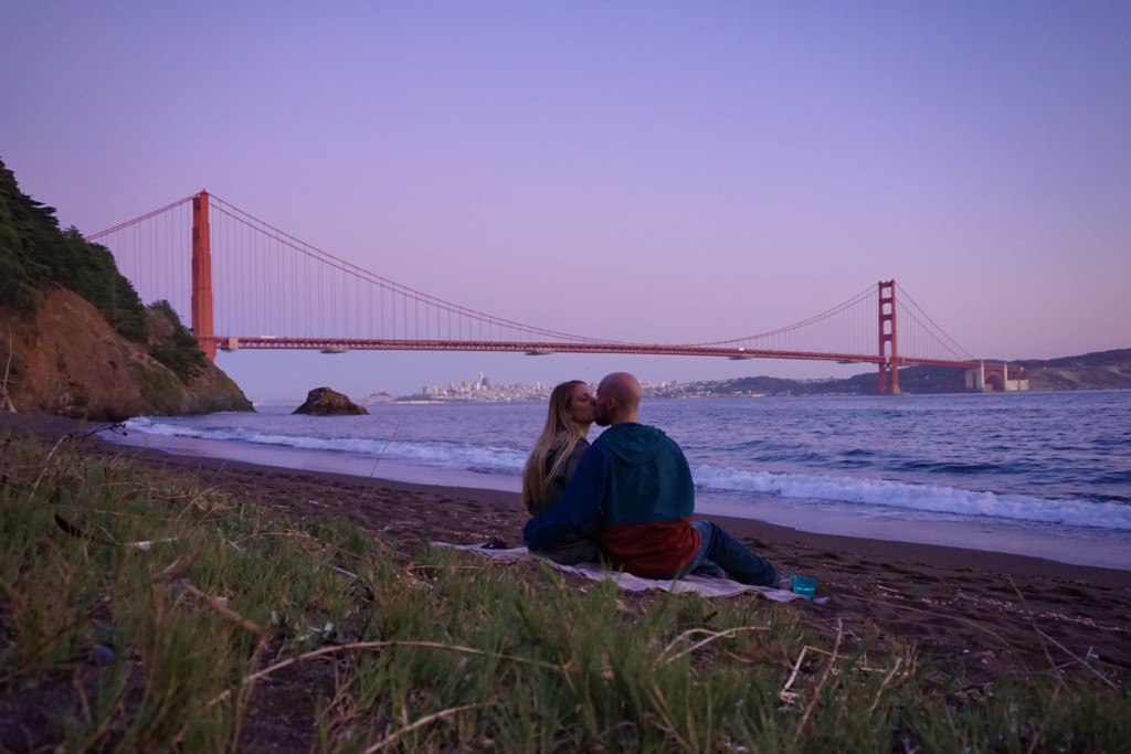 Jake and Emily on a romantic date with the Golden Gate Bridge in the background at Kirby Cove Beach