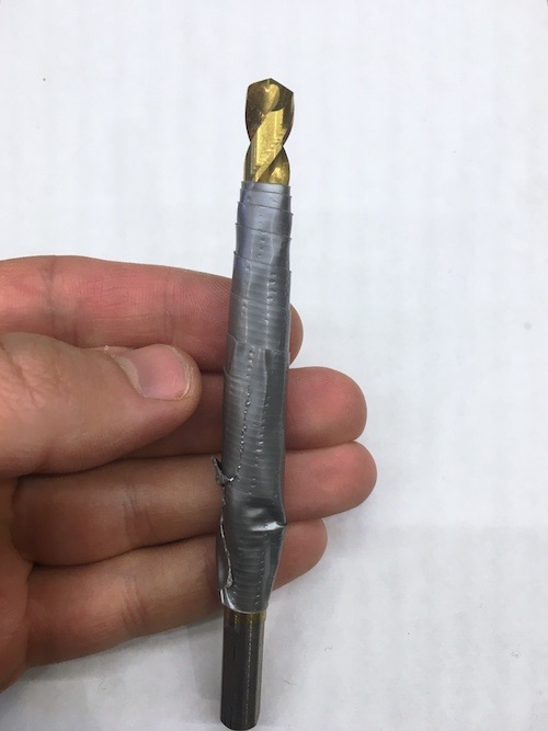 A drill bit covered with tape