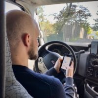 Jake using a phone app that is helping him with vanlife