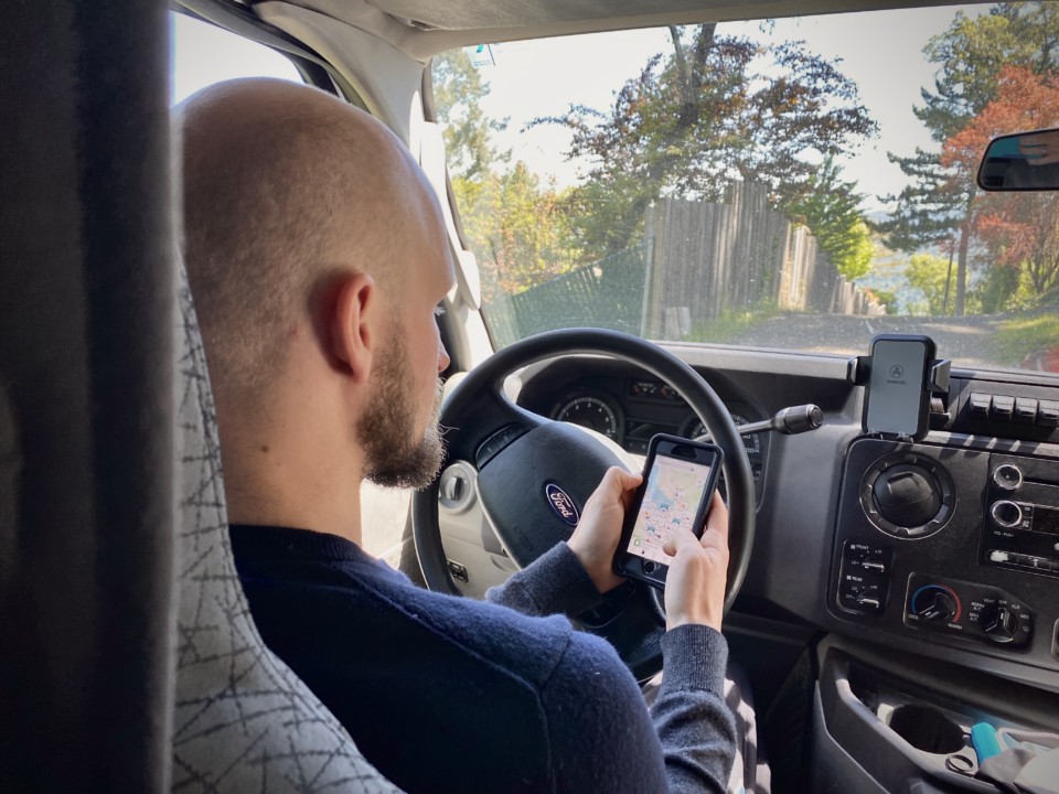 Jake using a phone app that is helping him with vanlife