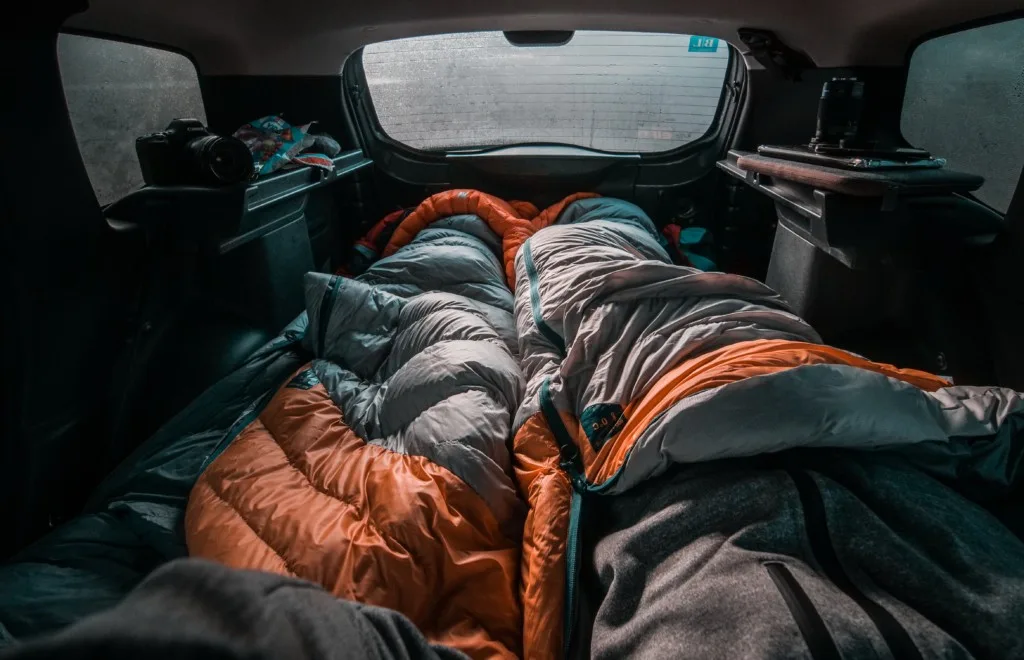 two sleeping bags in a car