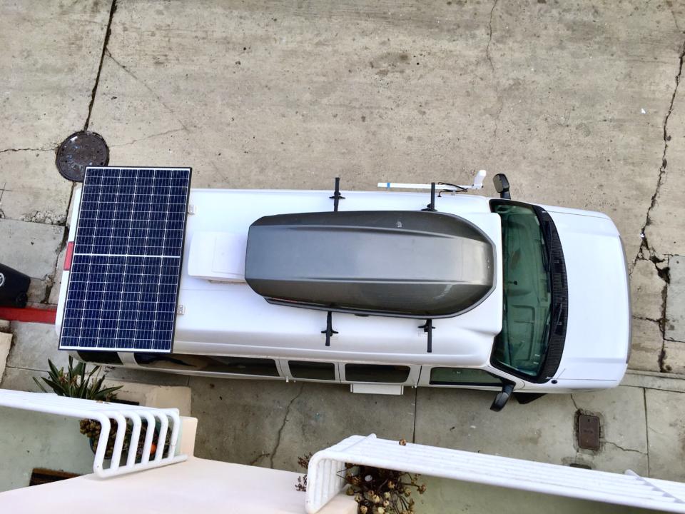 View of solar panels from above a campervan that is stealth camping