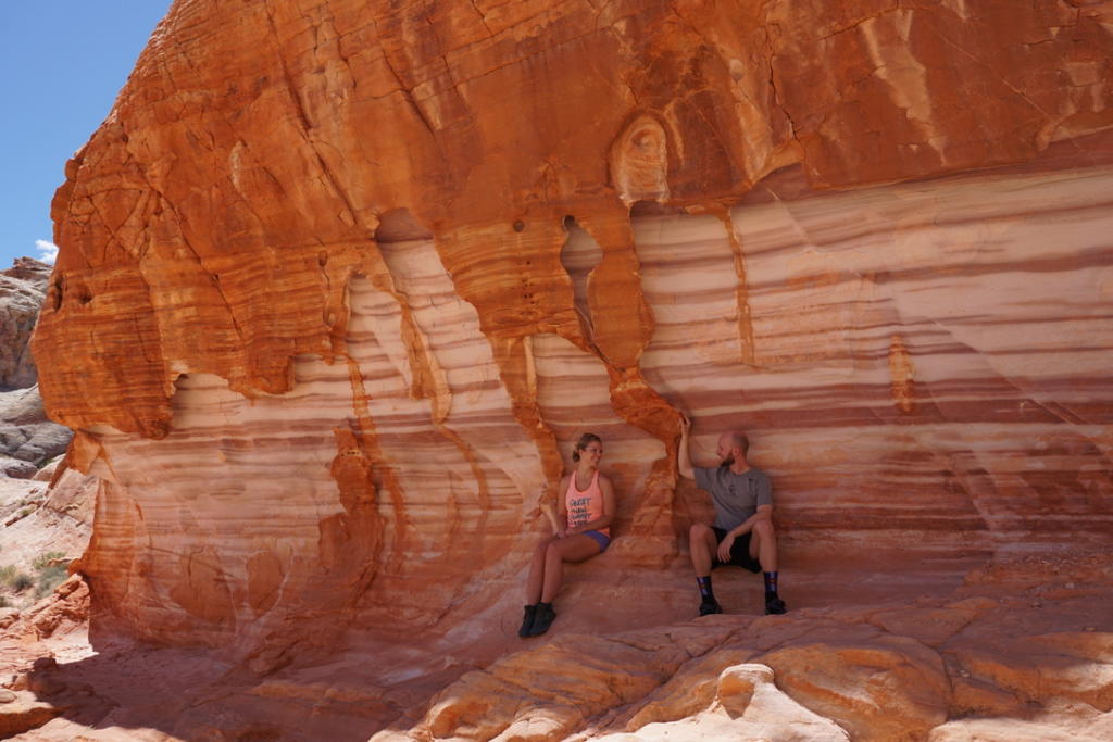 Jake and Emily sitting along Red and White Marble Wall on White Domes Trail in Valley Of Fire State Park