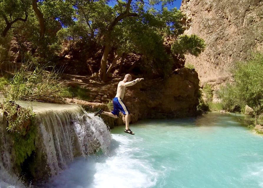 Jake jumping off a waterfall in Havasupai with Chacos on