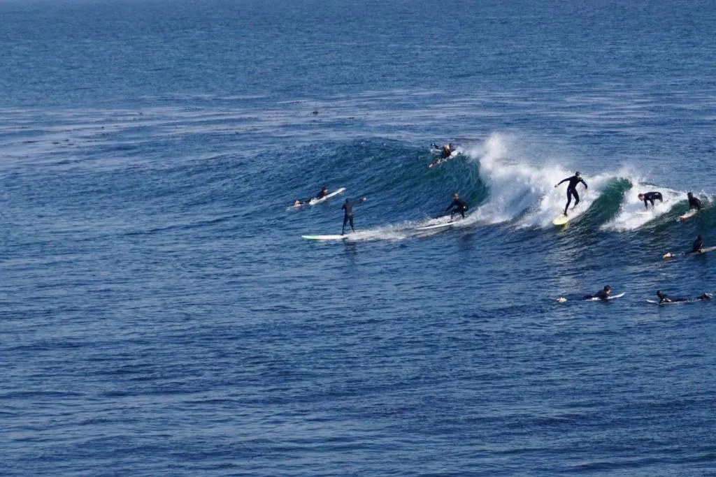 Multiple surfers surfing the same wave in Santa Cruz