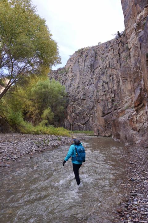 Emily hiking in a river in Aravaipa Canyon with river hiking shoes