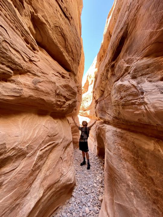 Jake with his arms up in White Domes slot canyon in valley of fire state park