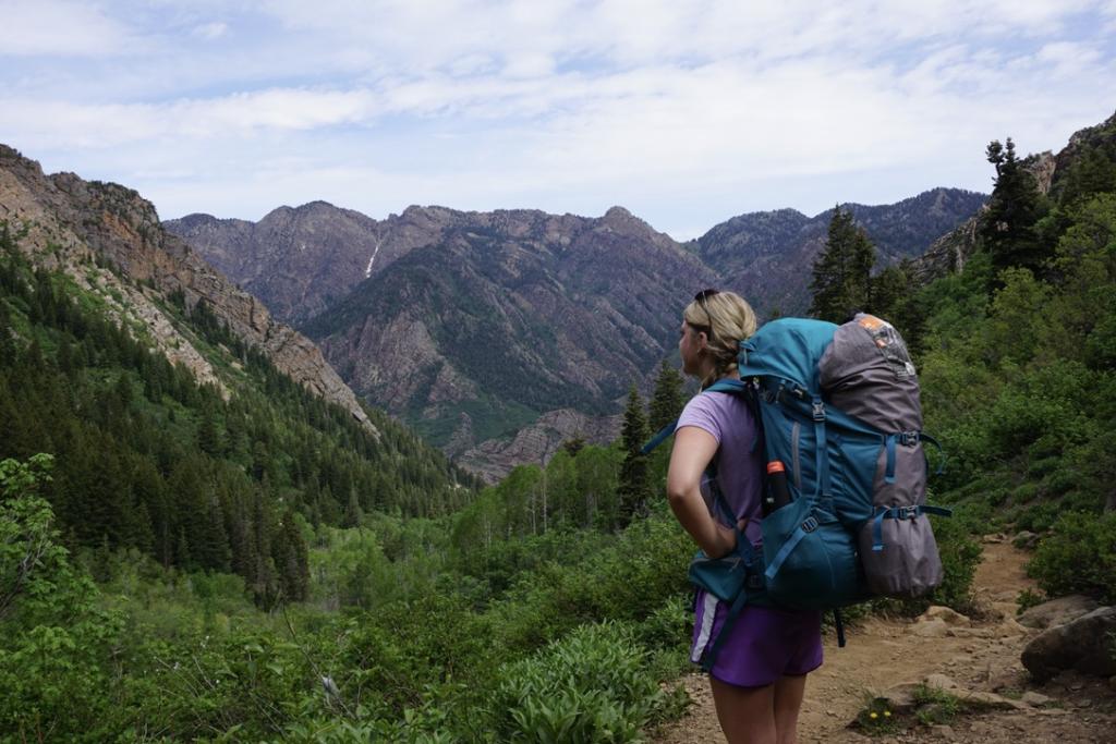 Emily with her backpacking pack on with the view toward the top of the Lake Blanche Trail