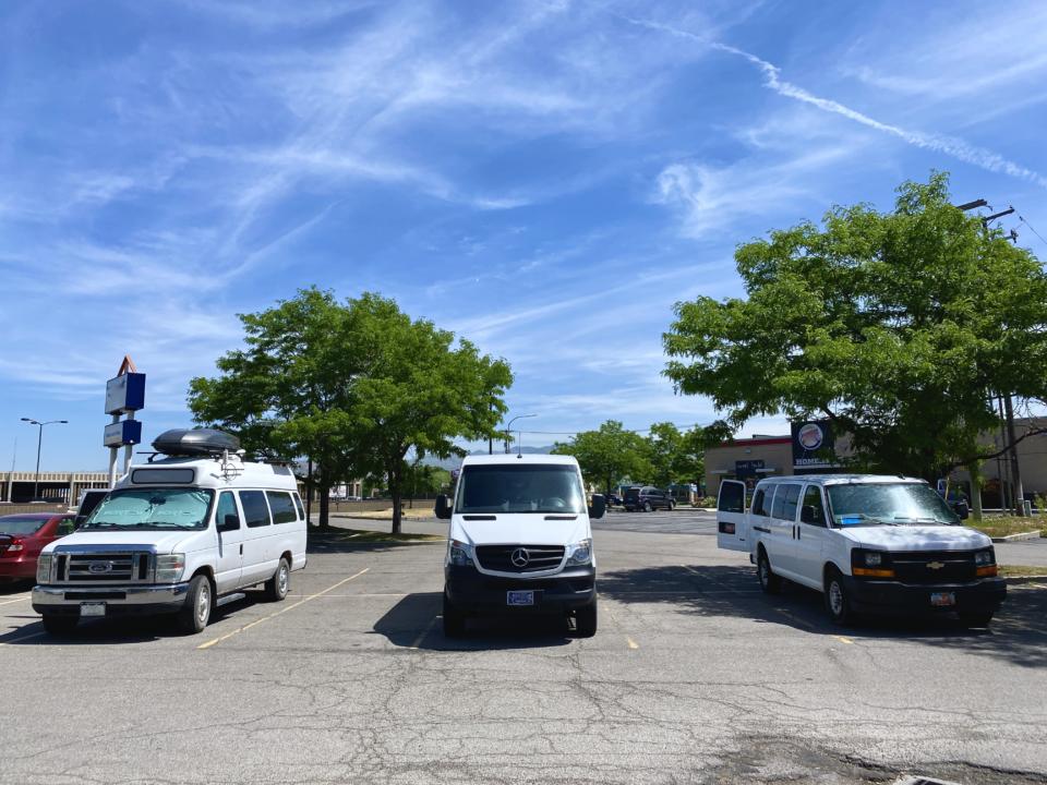 Three different types of white vans for stealth camping