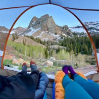View of Sundial Peak at Lake Blanche Through the tent with Jake and Emilys feet