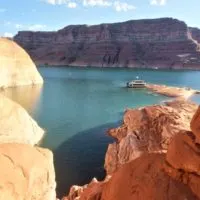 View of a houseboat in Lake Powell through a view of a canyon