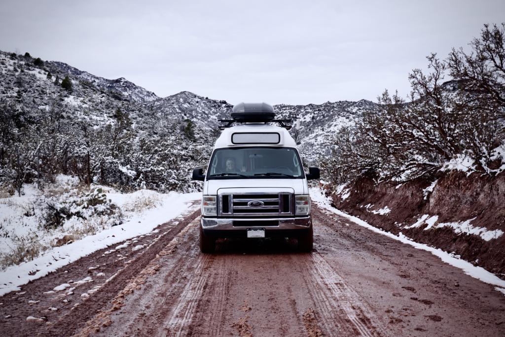 A campervan driving off-road on a muddy road, 2wd vs 4wd vans