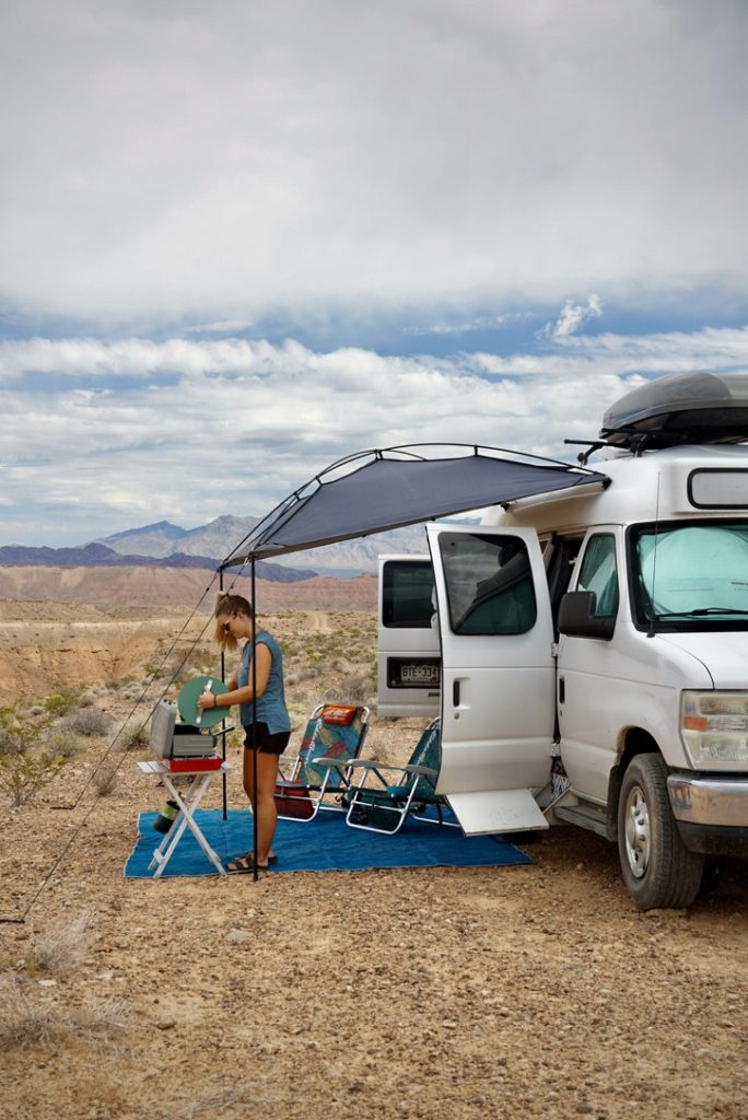 using the Moonshade in the desert for shade from the sun, which is one of the best van life gifts