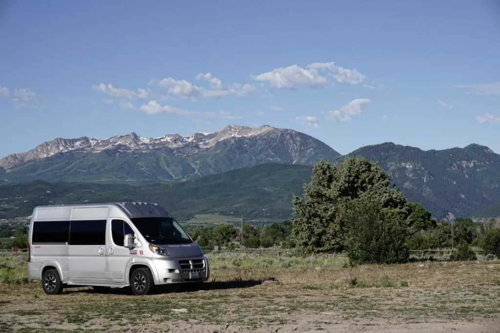 A Dodge Ram Promaster campervan in the mountains