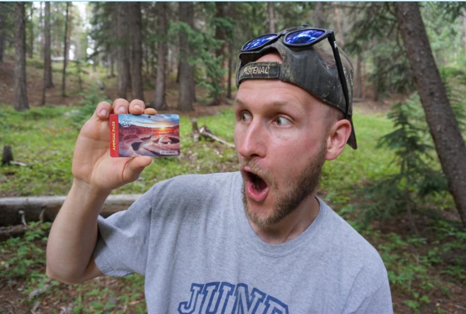 Jake Holding National Parks Pass, which makes the perfect van life gift