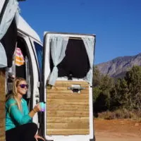 Emily enjoying a cup of coffee after learning how to make the best cup of coffee in vanlife