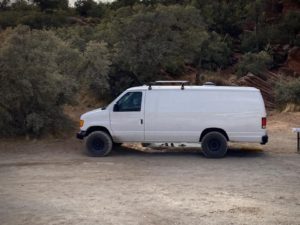 Ford E-series van extended with a lift and all-terrain tires