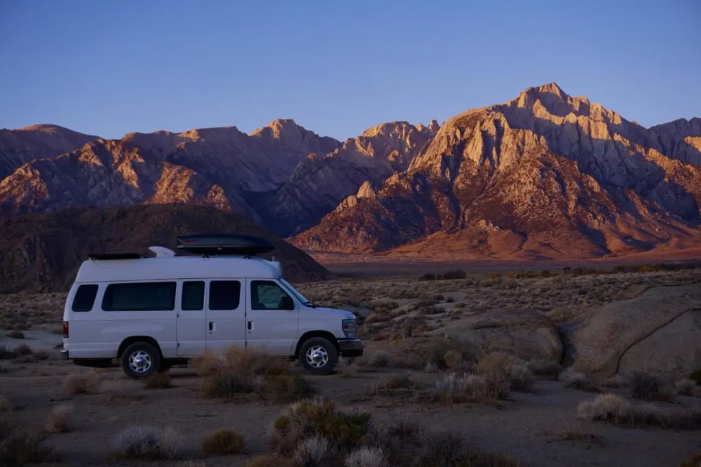 a camper van in front of the Alabama Hills Mountain Range at Sunrise