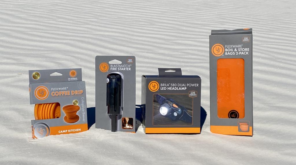 4 different products by ust gear layed out on the sand