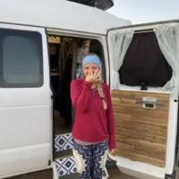 Emily covering her nose because she needs to minimize funky smells in a camper van