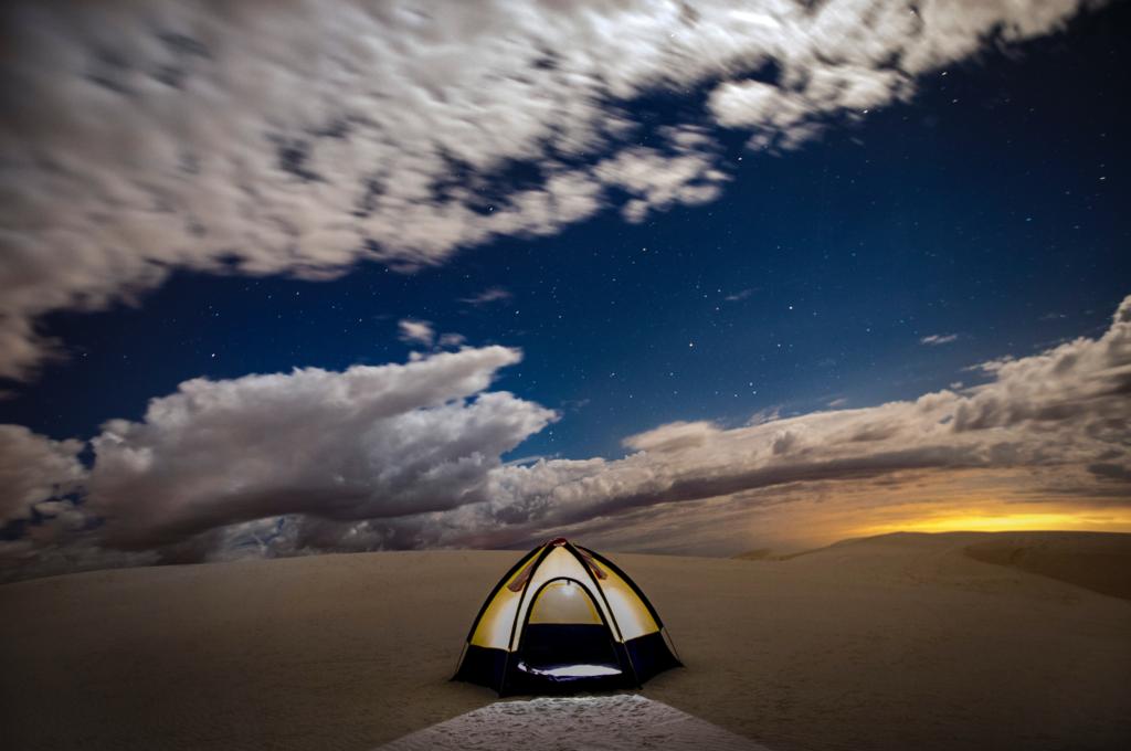 a tent lit up while backcountry camping in White Sands National Park