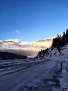 Winter roads convered in snow up a windy mountain pass.