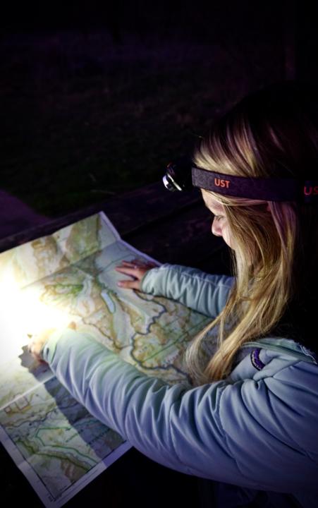 Emily Wearing The ust Gear Brila 580 Dual Power LED Headlamp to see a map at night