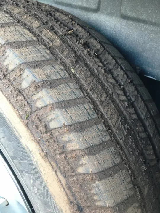 Mud stuck in the treads of a Michelin Defender LTX M/S tire.