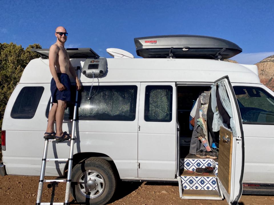 Jake setting up our advanced elements summer solar solar shower on our campervan