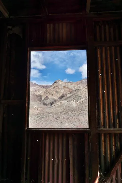 A window looking out of a building at Leadfield Ghost Town.