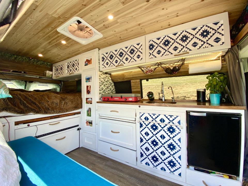 Campervan interior with decorative wallpaper cabinets.