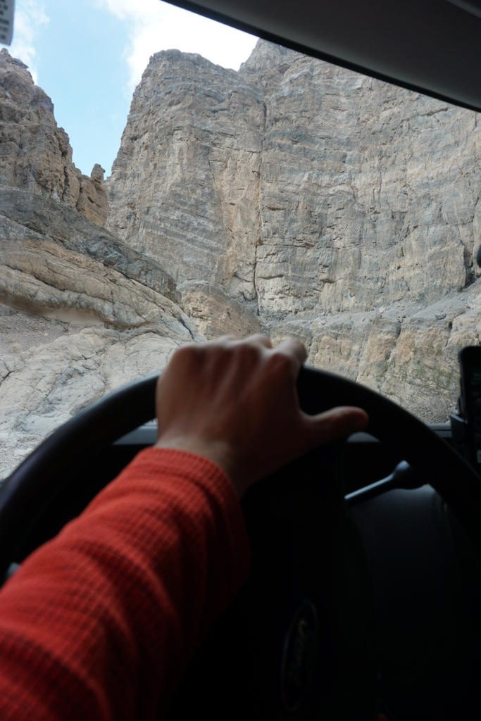 Looking out the windshield at the massive canyon walls of Titus Canyon